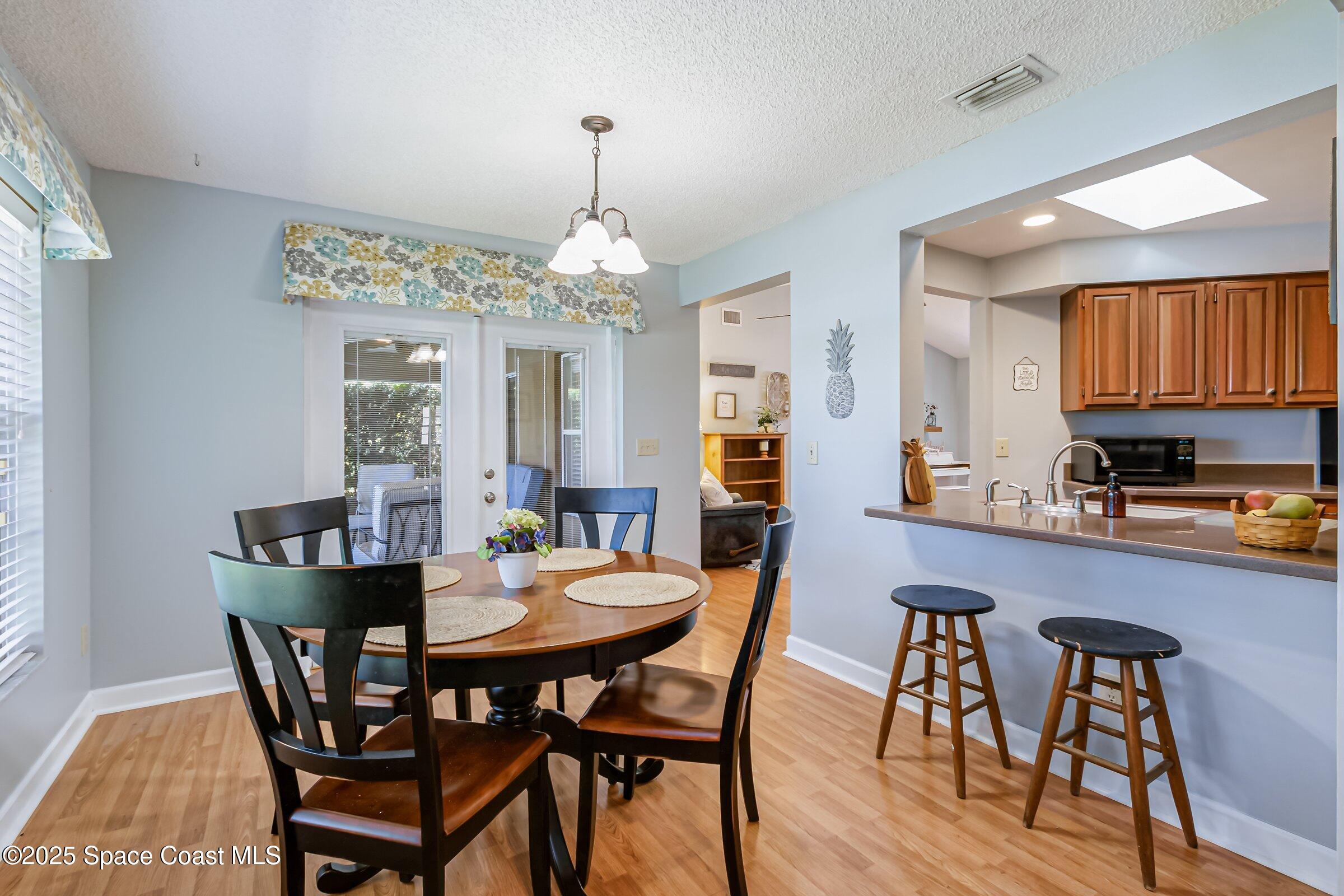 4351 Silver Lake Drive Melbourne, FL 32901 - Photo 20 of 55 a view of a dining room with furniture window and wooden floor