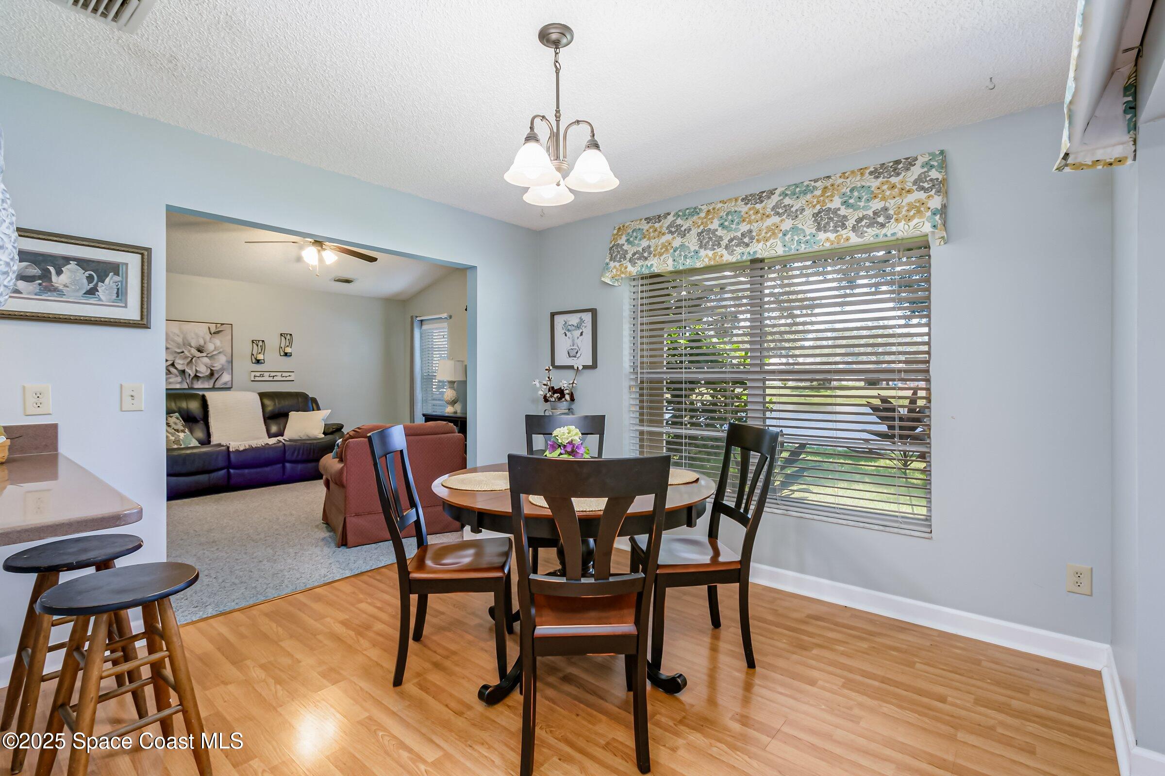 4351 Silver Lake Drive Melbourne, FL 32901 - Photo 21 of 55 a view of a dining room with furniture window and wooden floor