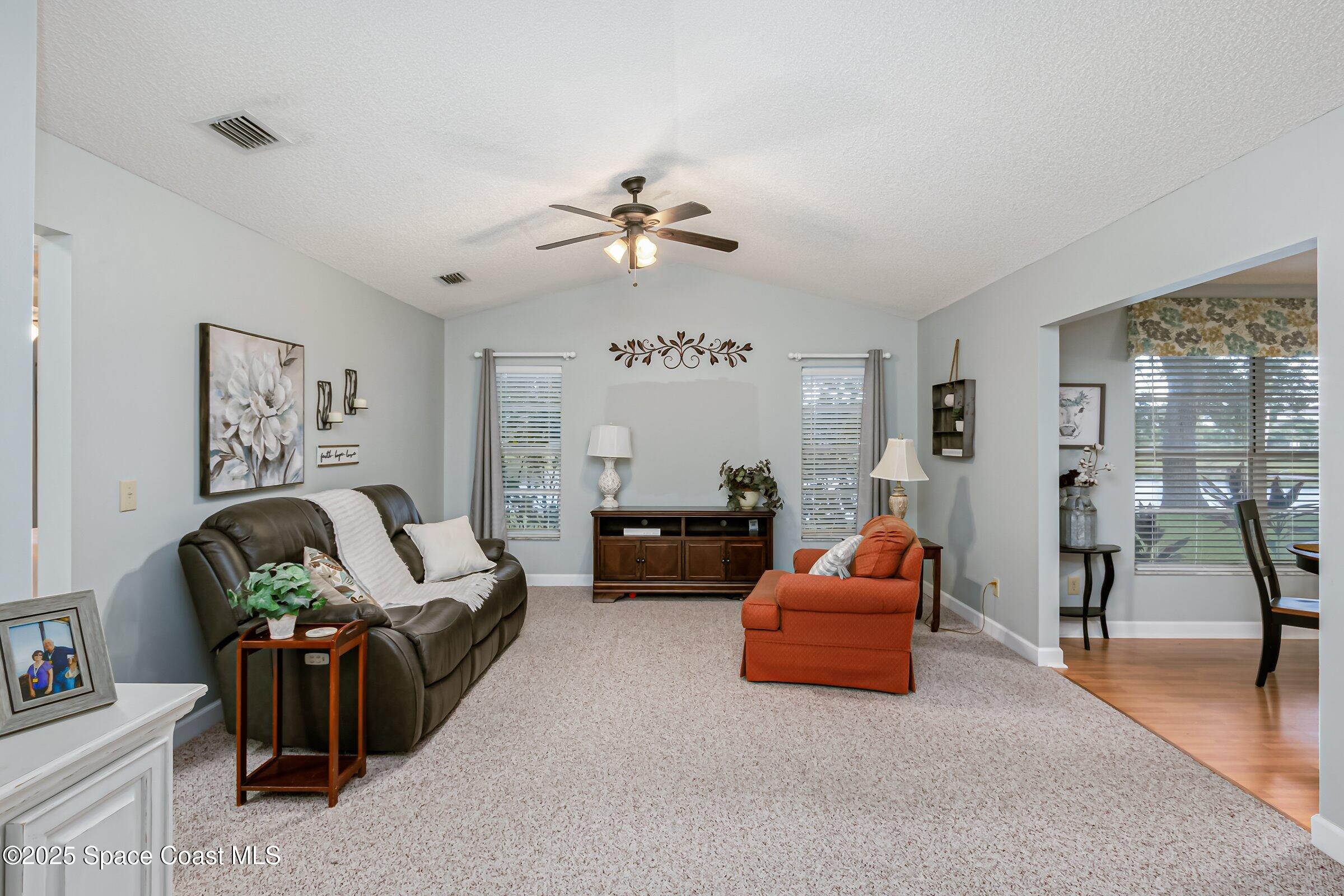 4351 Silver Lake Drive Melbourne, FL 32901 - Photo 22 of 55 a living room with furniture and a chandelier