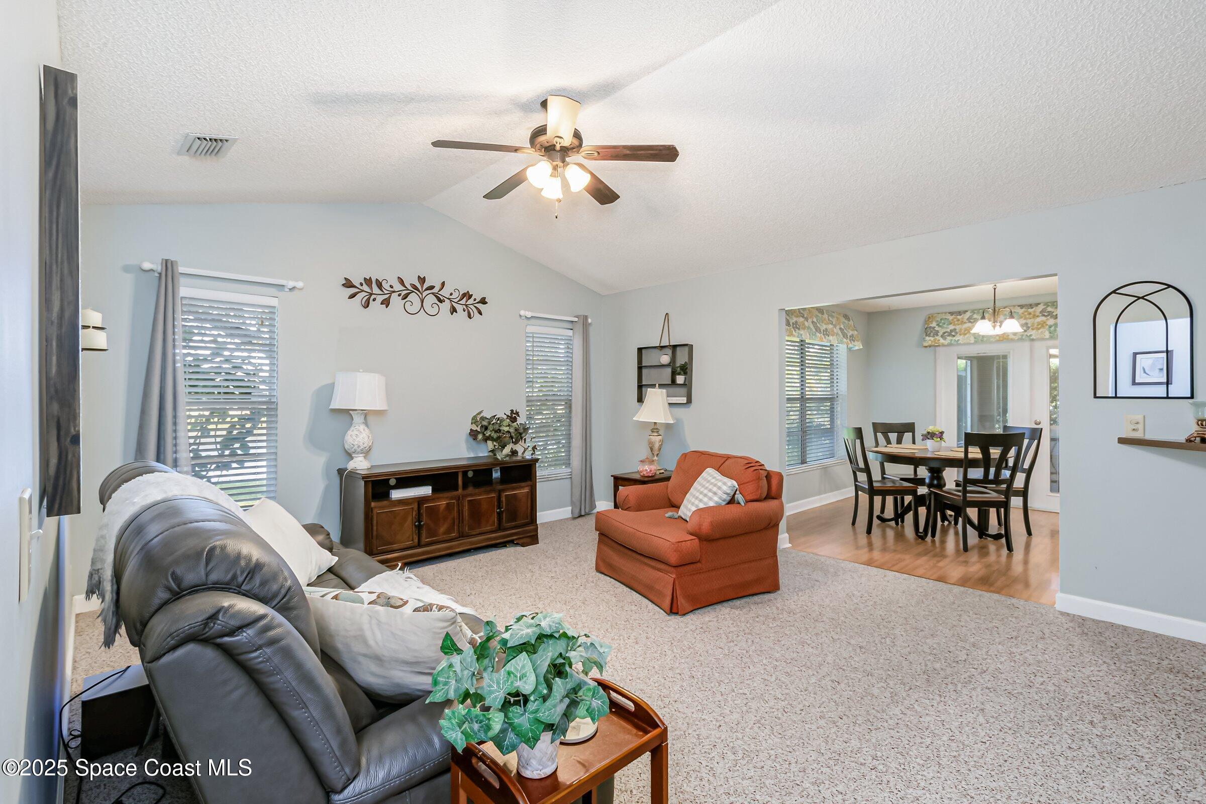 4351 Silver Lake Drive Melbourne, FL 32901 - Photo 24 of 55 a living room with furniture and a large window