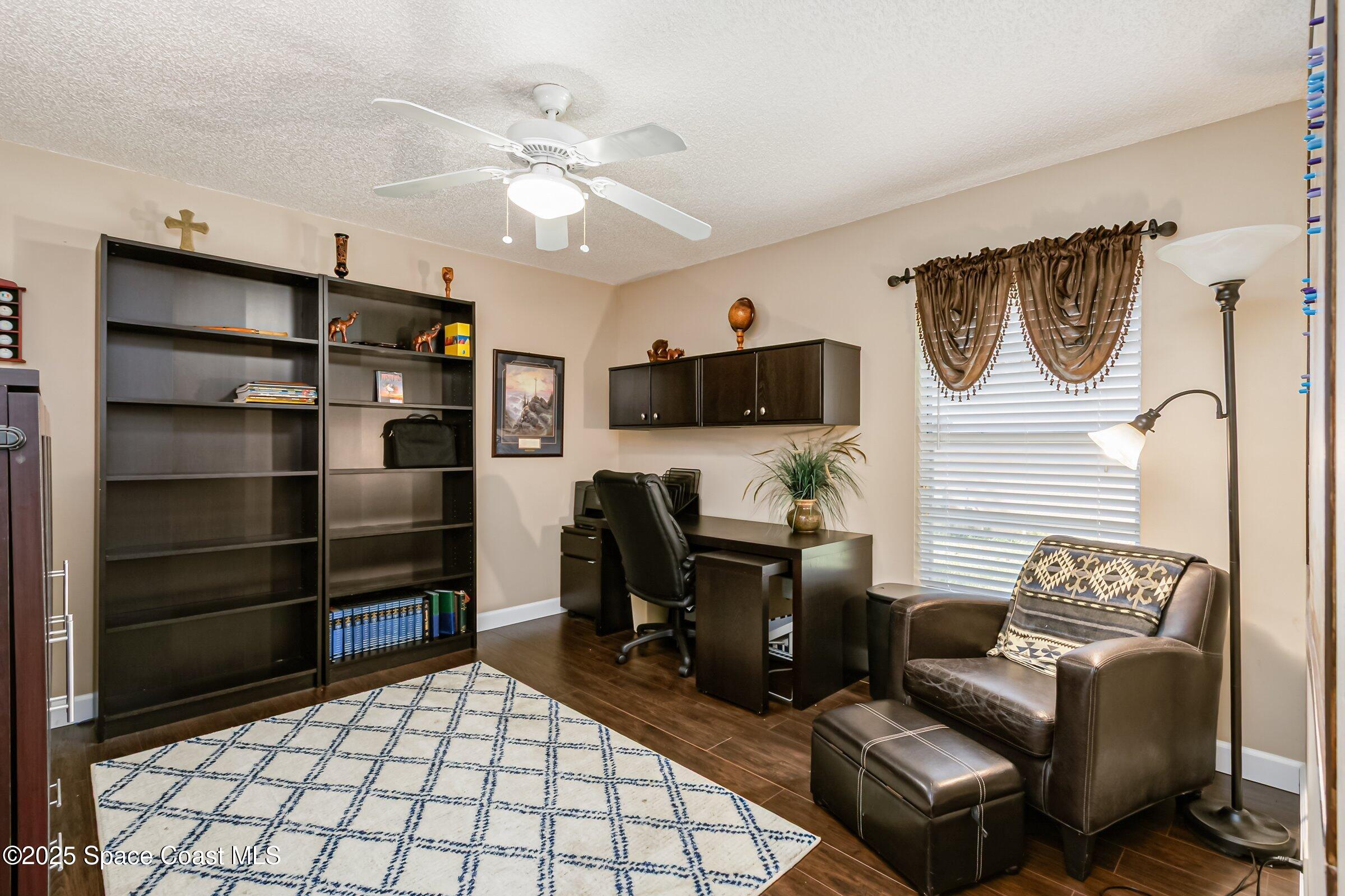 4351 Silver Lake Drive Melbourne, FL 32901 - Photo 30 of 55 a living room with furniture a flat screen tv and kitchen view
