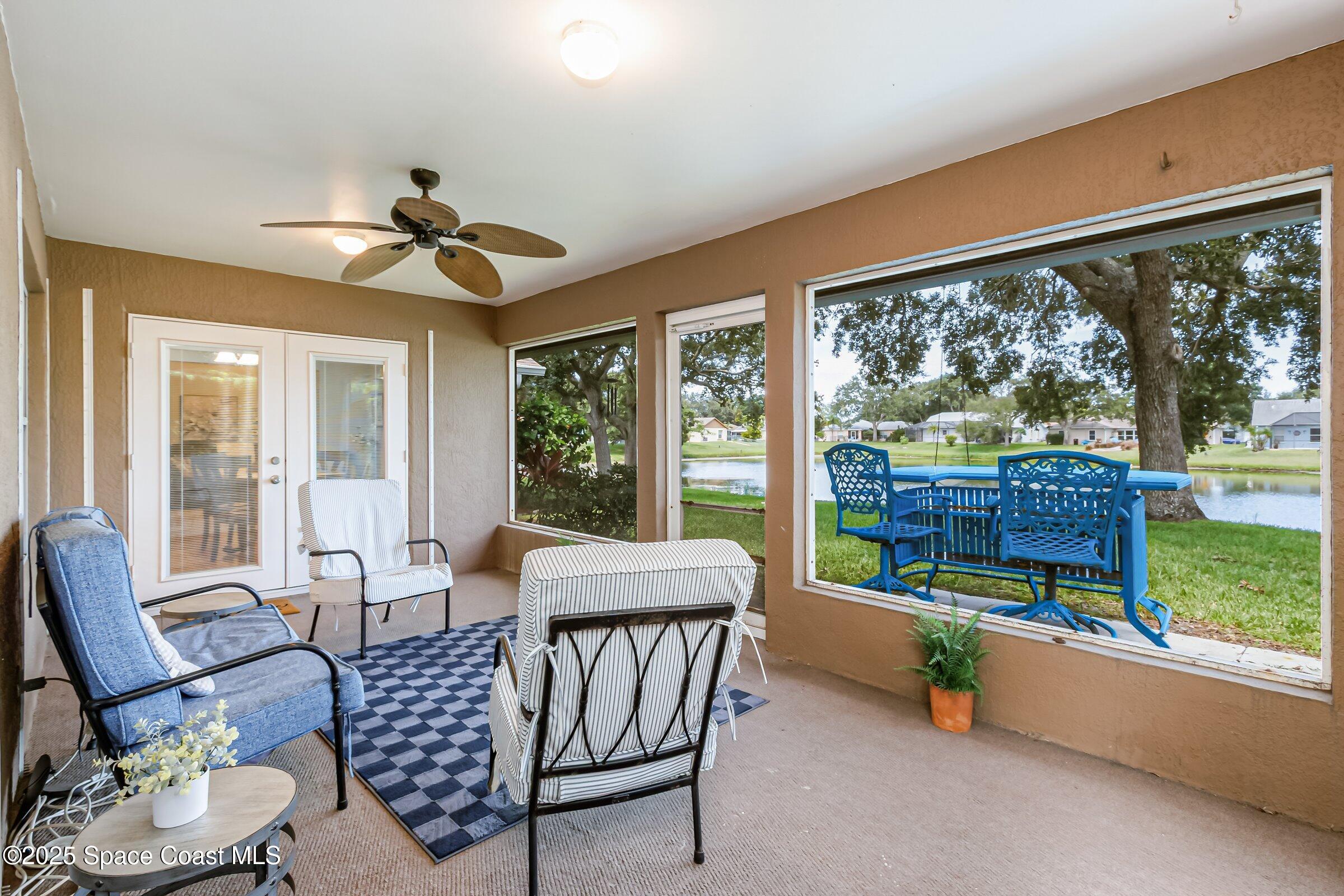 4351 Silver Lake Drive Melbourne, FL 32901 - Photo 32 of 55 a dining room with furniture and a floor to ceiling window