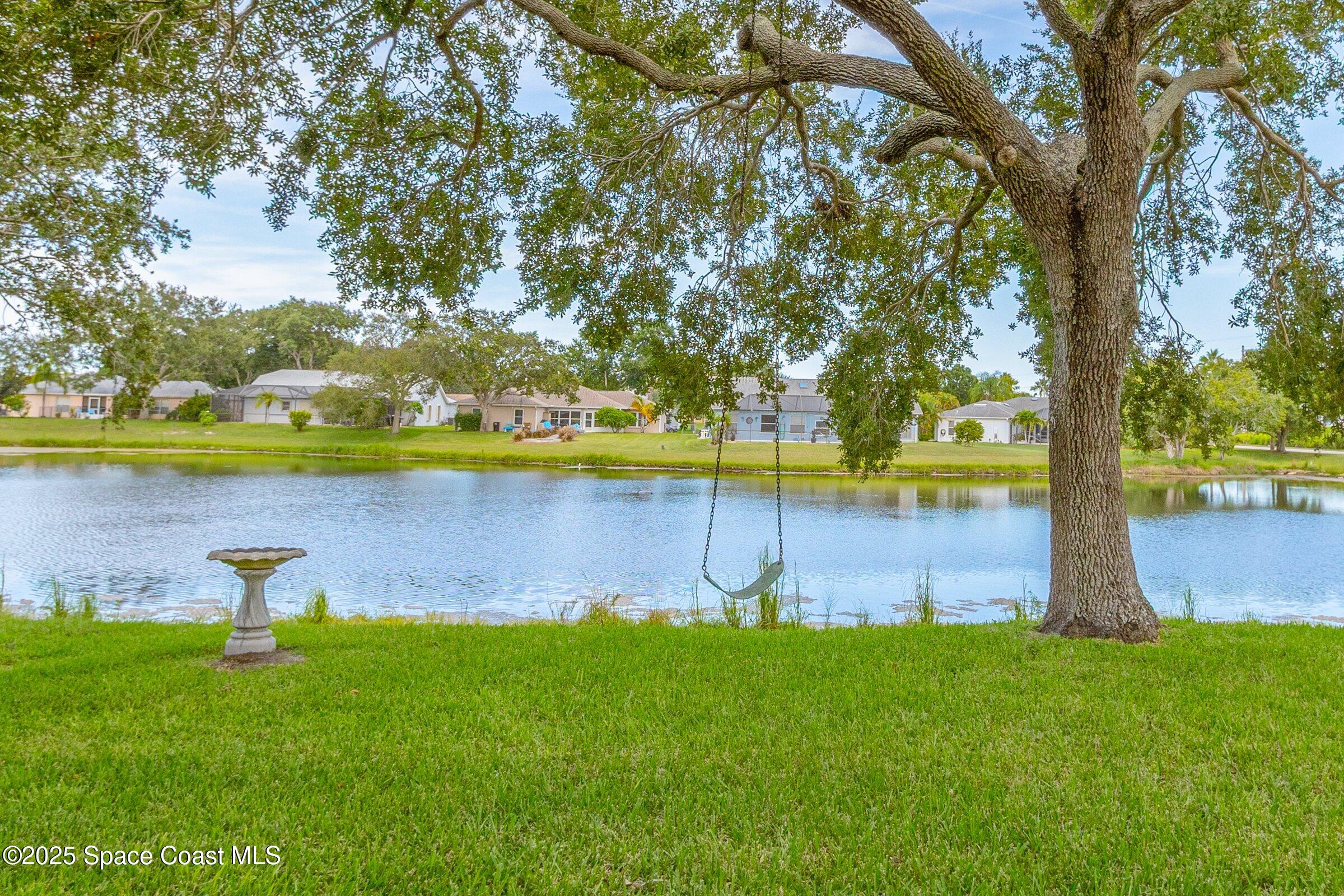 4351 Silver Lake Drive Melbourne, FL 32901 - Photo 36 of 55 a view of a house with a yard and a large tree