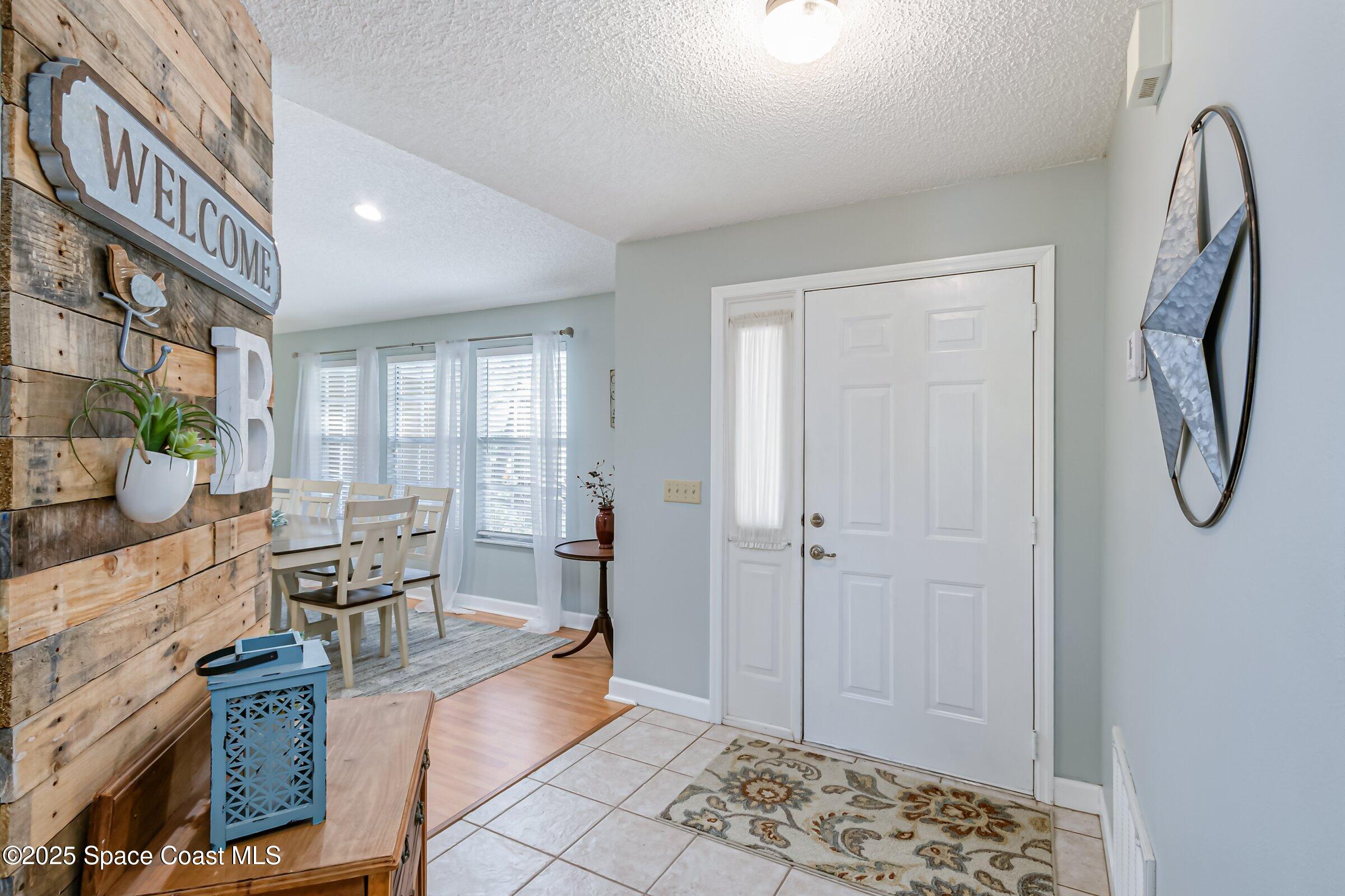 4351 Silver Lake Drive Melbourne, FL 32901 - Photo 4 of 55 a living room with furniture a chandelier and a window