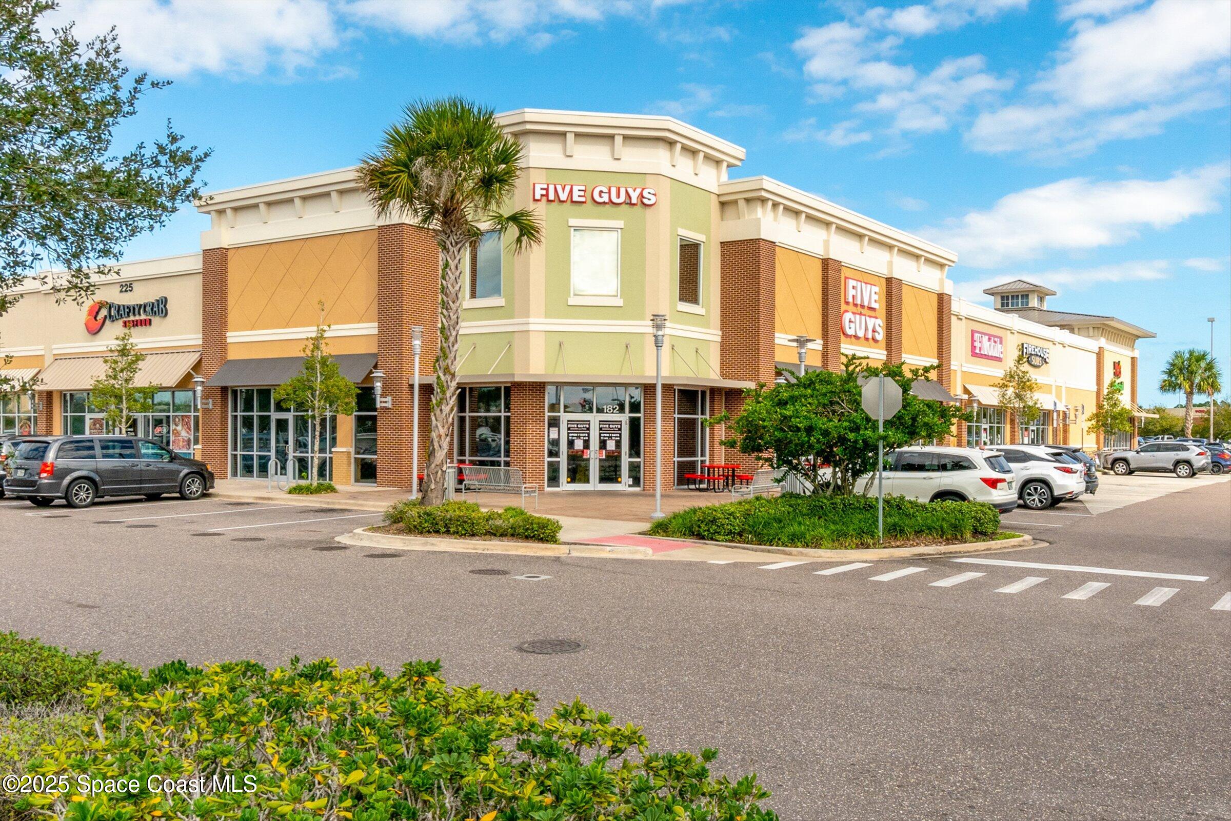4351 Silver Lake Drive Melbourne, FL 32901 - Photo 50 of 55 a front view of a building with garden and parking