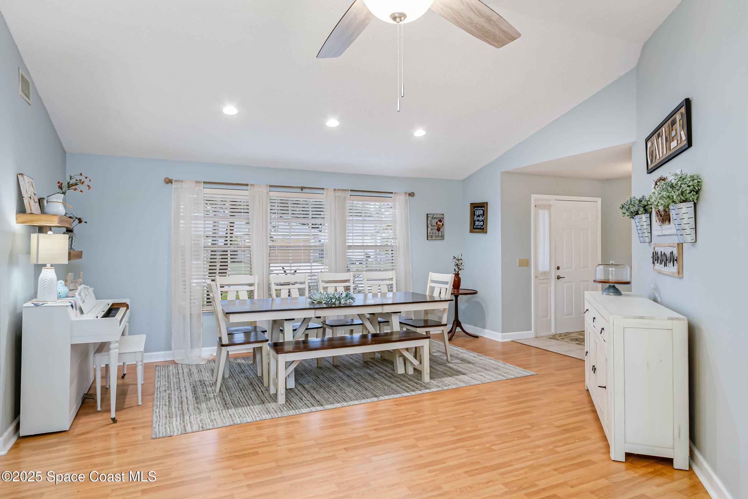 4351 Silver Lake Drive Melbourne, FL 32901 - Photo 7 of 55 a living room with furniture a wooden floor and next to a window