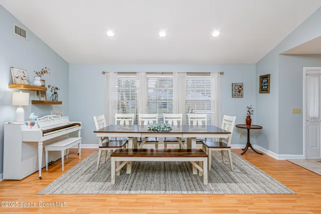 a living room with furniture wooden floor and a table