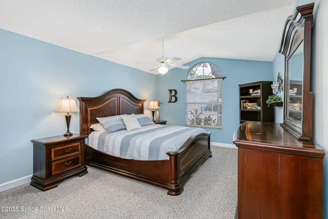 a bed room with a bed and a chandelier