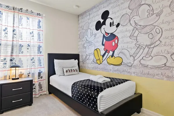 a bedroom with a bed and painting on the wall