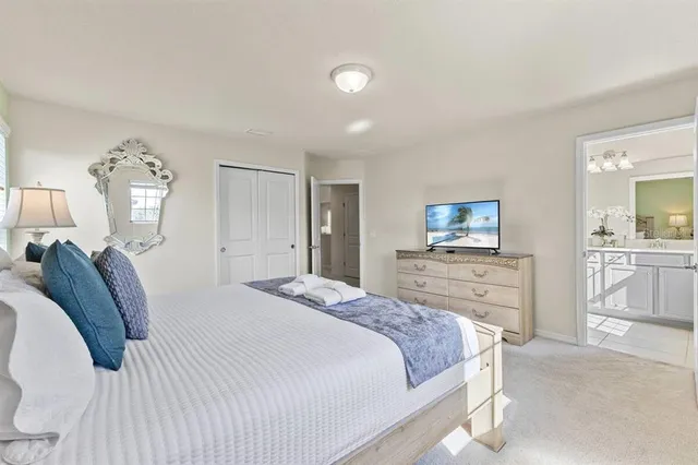 a bedroom with a bed and a television