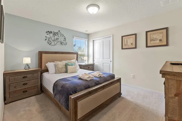 a bedroom with a bed and a painting on the wall