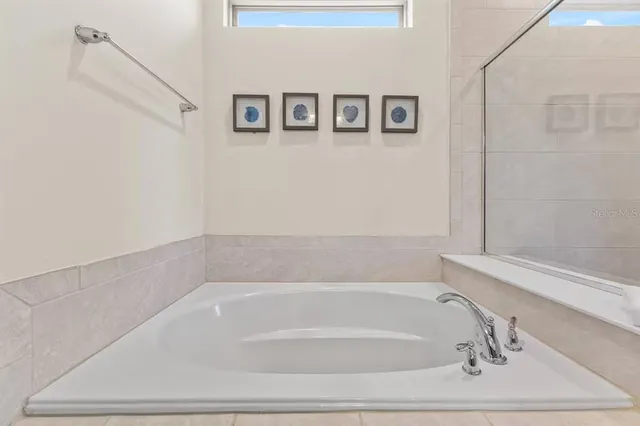 a bathroom with bathtub and shower