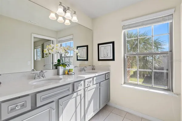 a bathroom with a double vanity sink and a mirror