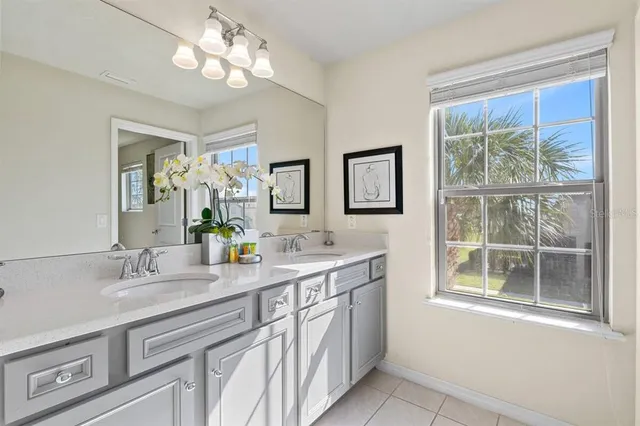 a bathroom with a double vanity sink and a mirror