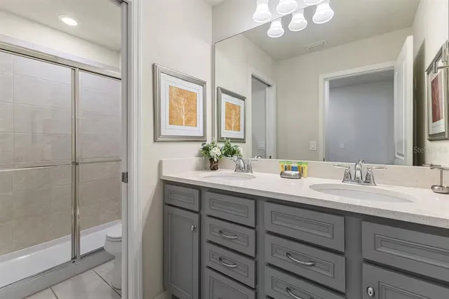 a bathroom with a double vanity sink mirror and double