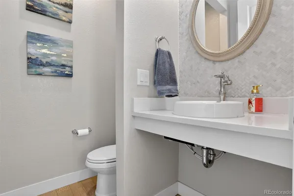 a bathroom with a sink mirror and toilet