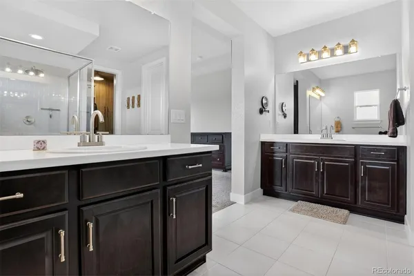 a bathroom with a sink vanity and a mirror