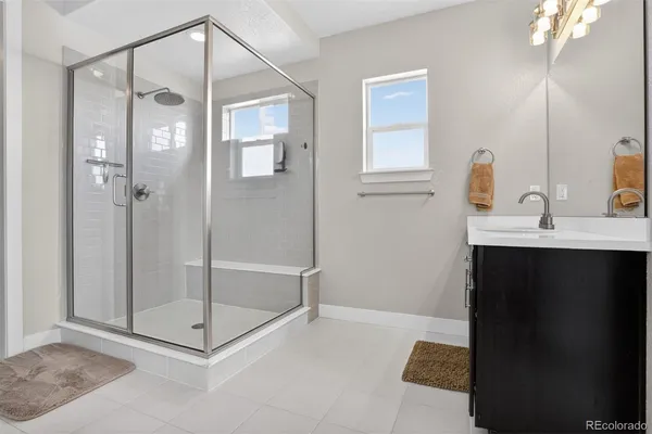 a bathroom with a shower sink and mirror
