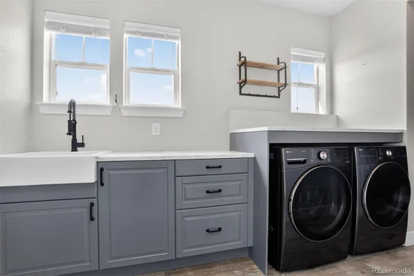 a utility room with cabinets dryer and washer