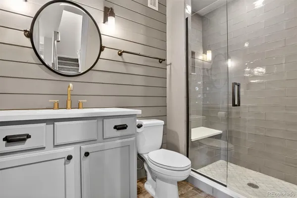 a bathroom with a sink a mirror and a shower