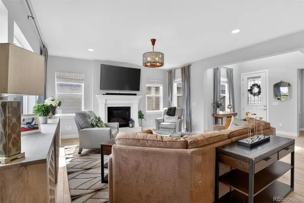 a living room with fireplace furniture and a flat screen tv