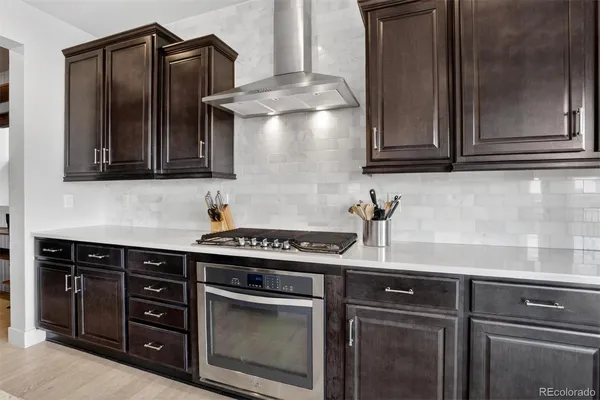 a kitchen with stainless steel appliances granite countertop a stove and a microwave