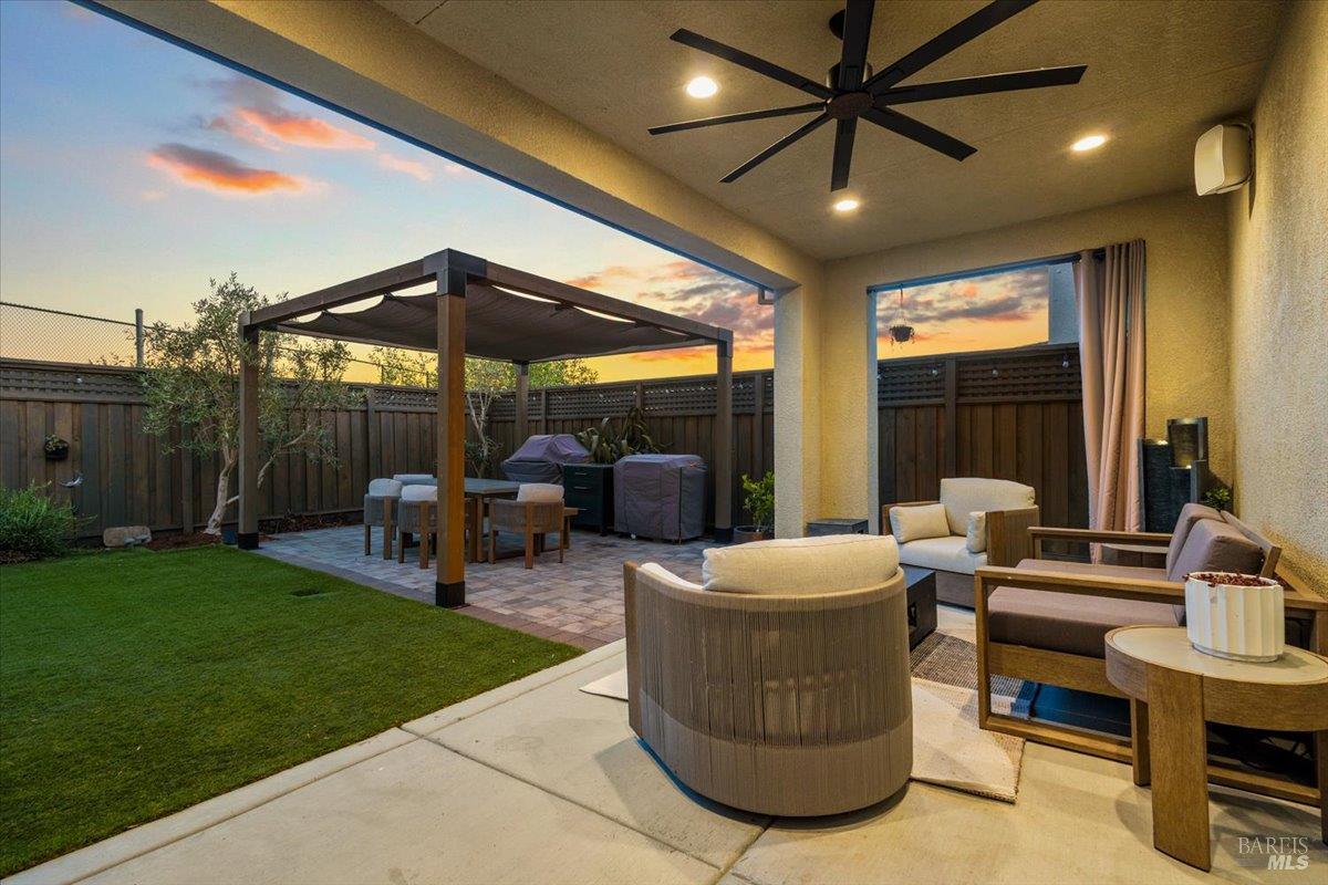 1469 Oak Circle Rohnert Park, CA 94928 - Photo 40 of 42 A Backyard You'll Never Want to Leave As dusk settles in, the covered patio, dining pergola, and beautifully landscaped yard create a private outdoor sanctuary designed for gathering, relaxing, and making memories.