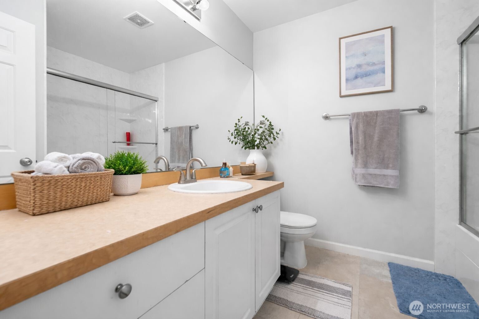 16373 119th Terrace Northeast, Unit 315 Bothell, WA 98011 - Photo 12 of 27 a bathroom with a granite countertop sink and a mirror