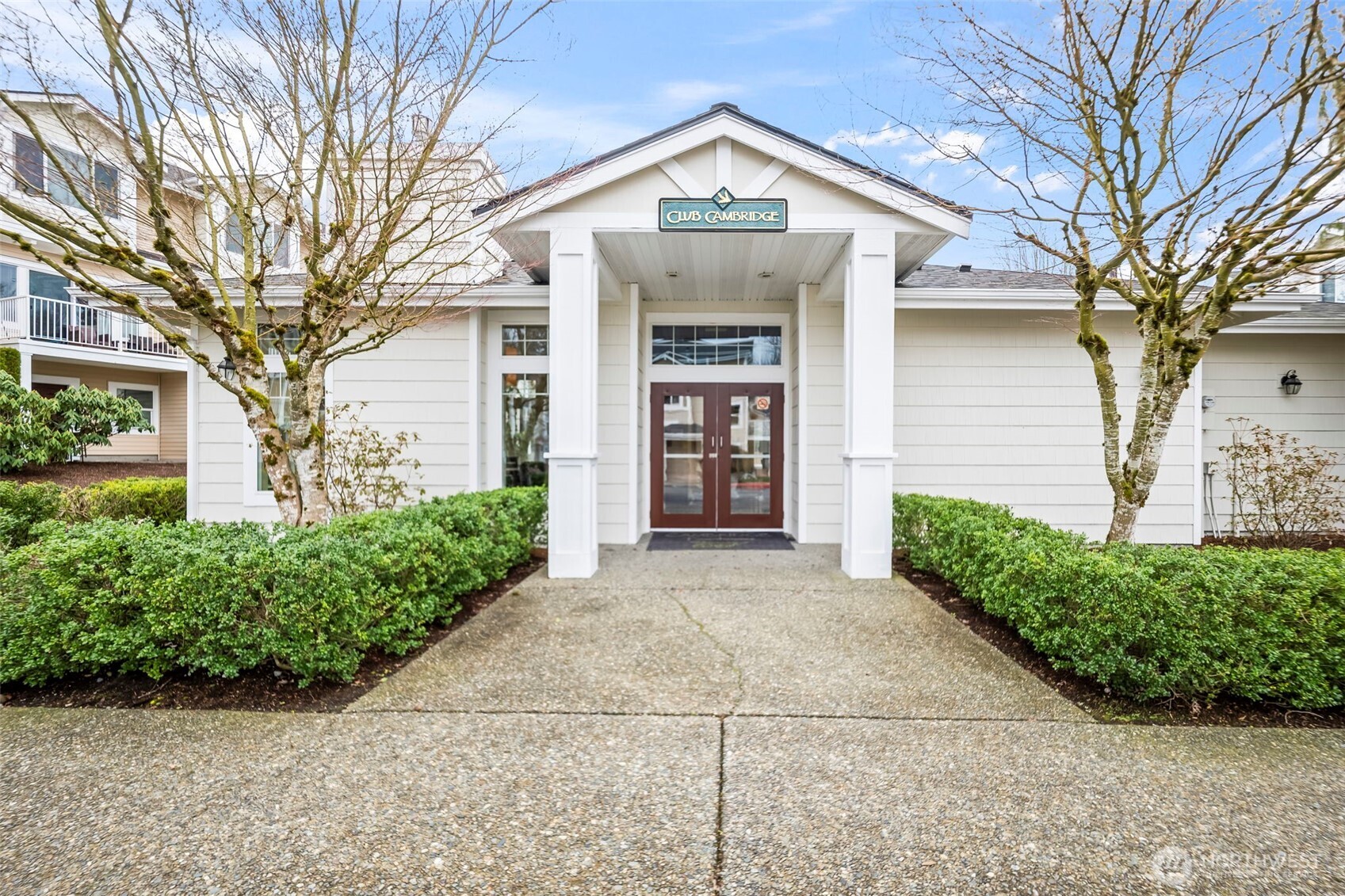 16373 119th Terrace Northeast, Unit 315 Bothell, WA 98011 - Photo 18 of 27 a front view of a house with a yard and potted plants
