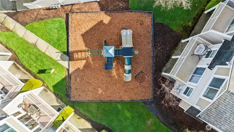 an aerial view of a house with a yard and furniture