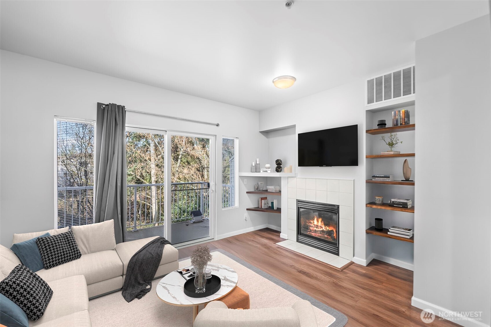 16373 119th Terrace Northeast, Unit 315 Bothell, WA 98011 - Photo 3 of 27 a living room with furniture a flat screen tv and a fireplace