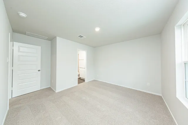 an empty room with closet area