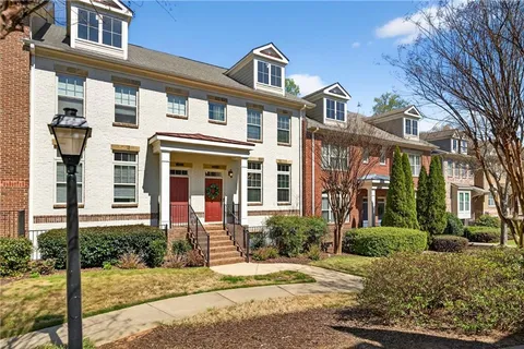 front view of a brick house with a yard