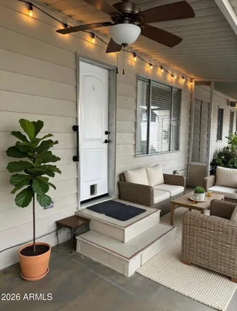 a building outdoor space with patio furniture and potted plants