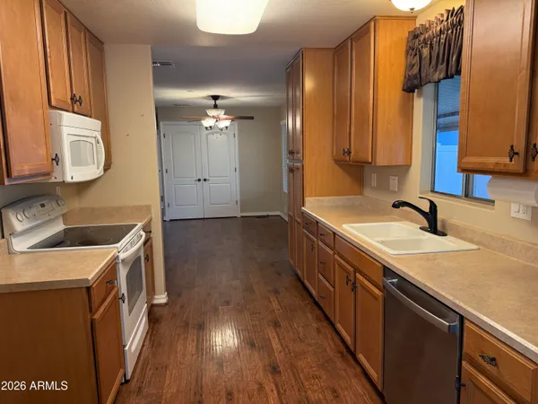 a kitchen with a sink stove and cabinets