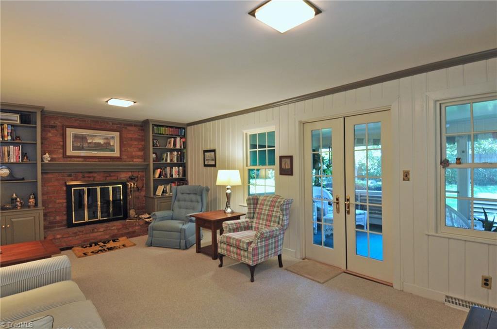 Den, hardwoods under carpet.
