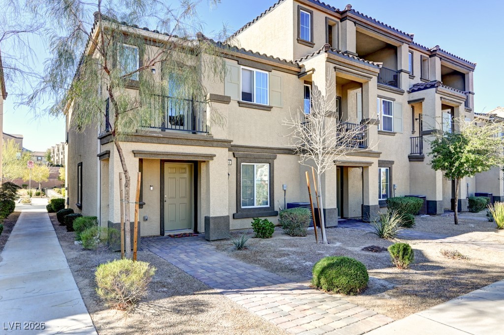 Mediterranean / spanish-style home featuring a balcony and stucco siding