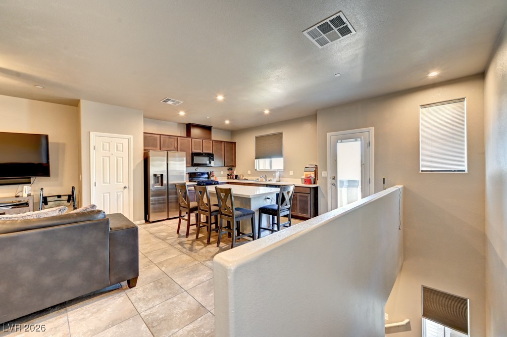 1284 Arcadia Rim Place Henderson, NV 89002 - Photo 11 of 27 Living room with light tile patterned flooring and recessed lighting