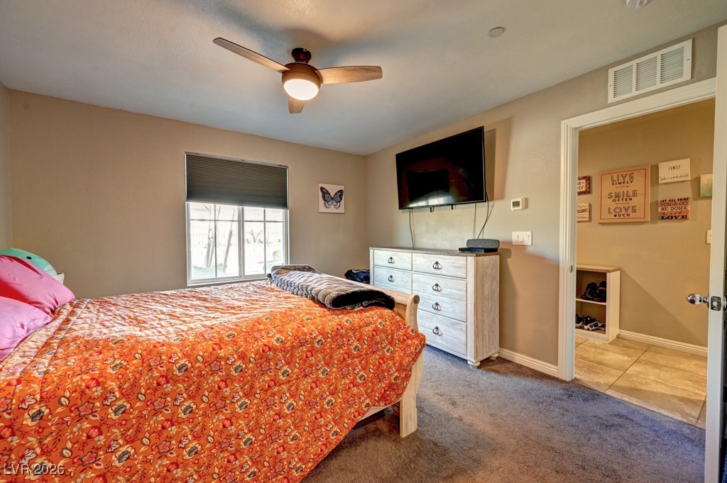 1284 Arcadia Rim Place Henderson, NV 89002 - Photo 12 of 27 Tiled bedroom with a ceiling fan and carpet floors