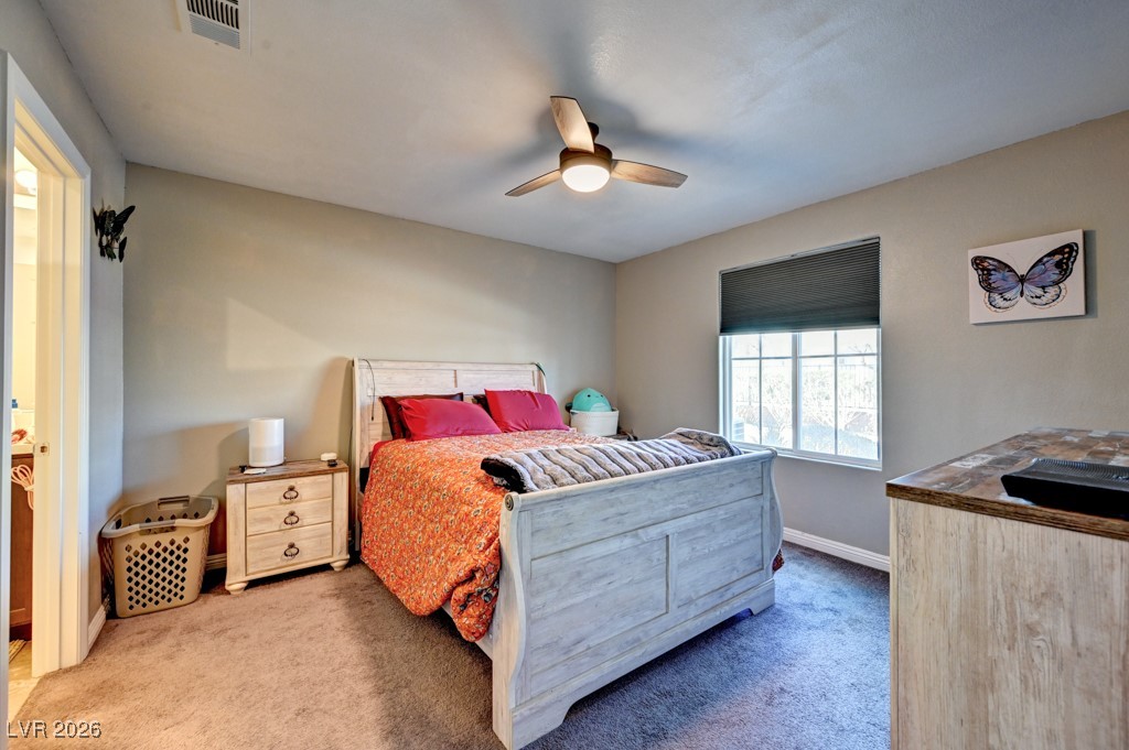 1284 Arcadia Rim Place Henderson, NV 89002 - Photo 14 of 27 Carpeted bedroom with a ceiling fan and connected bathroom