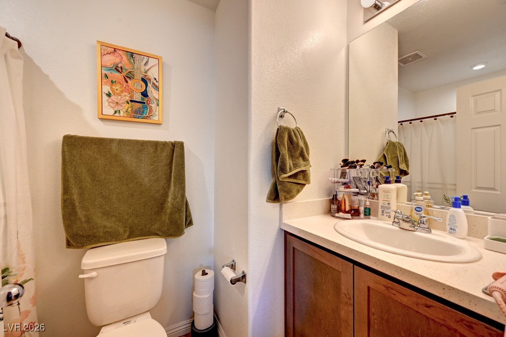 1284 Arcadia Rim Place Henderson, NV 89002 - Photo 15 of 27 Bathroom featuring curtained shower and vanity