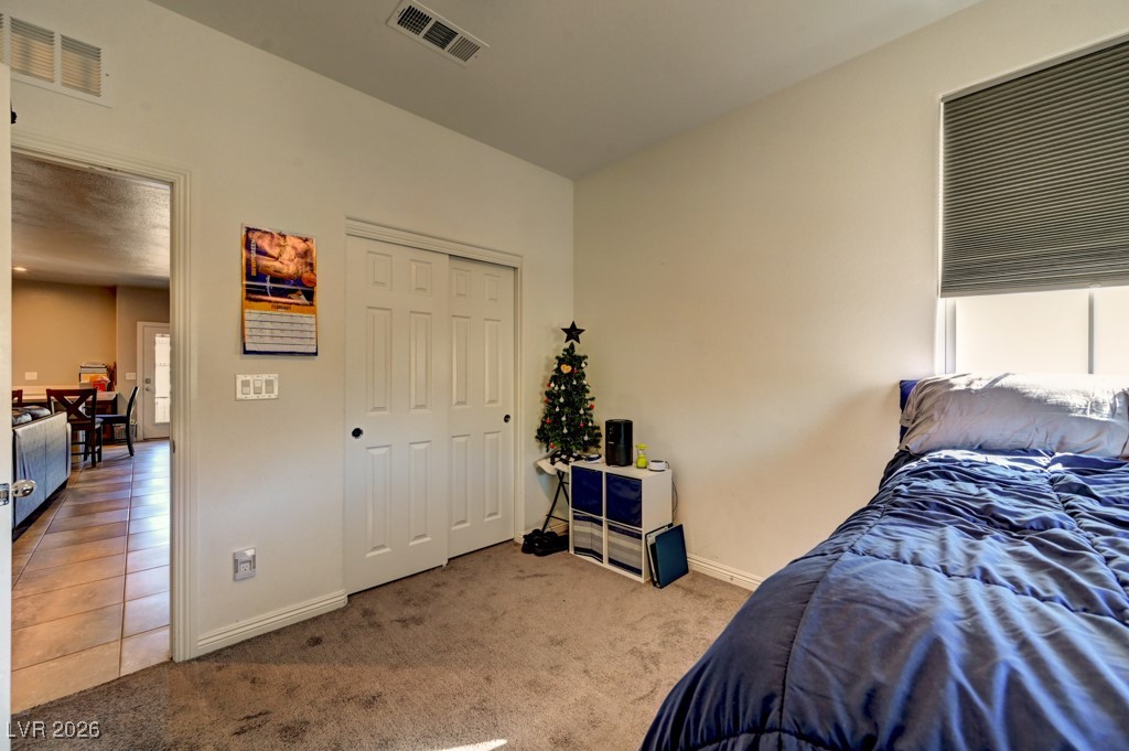 1284 Arcadia Rim Place Henderson, NV 89002 - Photo 21 of 27 Carpeted bedroom with baseboards and a closet