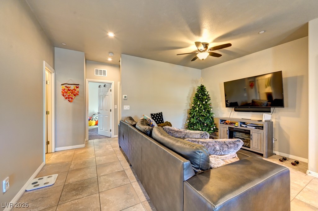 1284 Arcadia Rim Place Henderson, NV 89002 - Photo 6 of 27 Living room with a ceiling fan, light tile patterned flooring, and recessed lighting