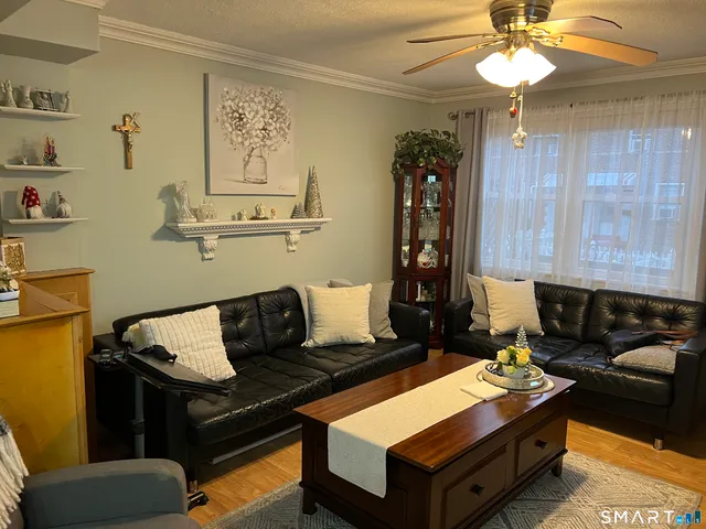 a living room with furniture and a chandelier