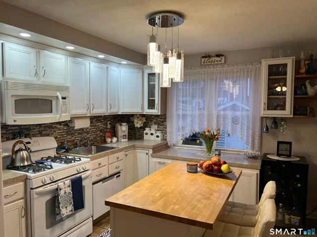 a kitchen with a stove a sink and a refrigerator