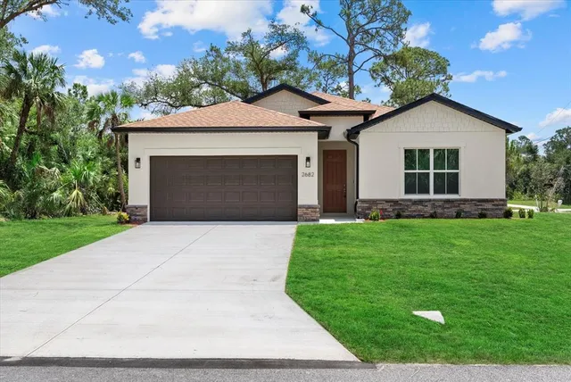 a front view of a house with a yard and garage