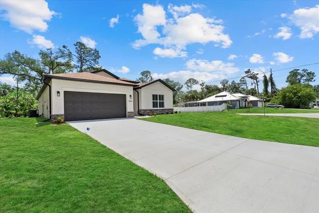 a front view of a house with a garden and yard