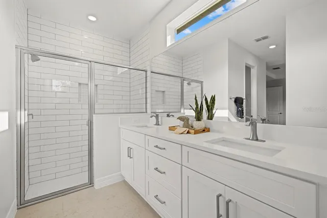 a bathroom with a double vanity sink and mirror