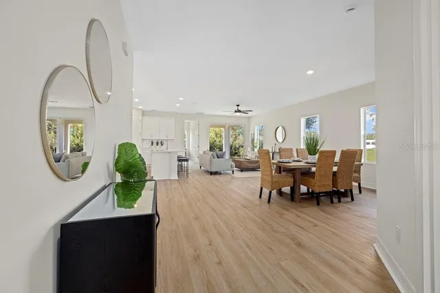 a living room with furniture a window and a potted plant