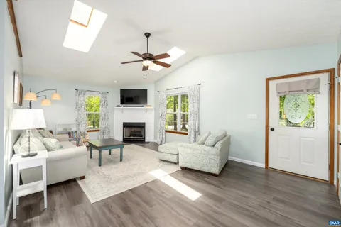 a living room with furniture fireplace and flat screen tv